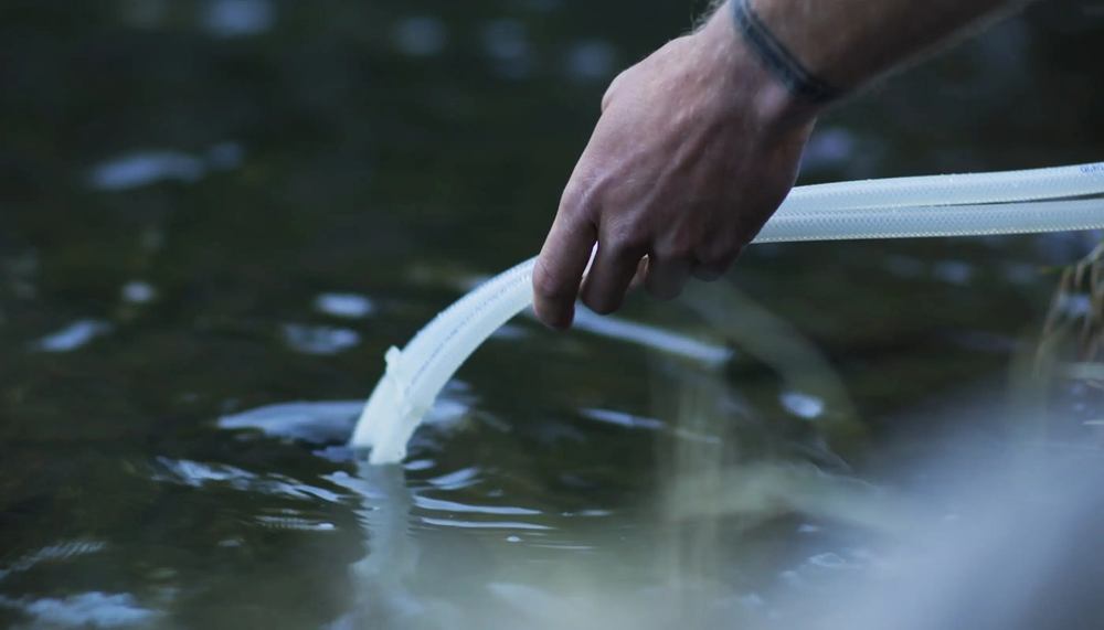 Vital Lyfe Access intake hose drawing water from a river Vital Lyfe Access intake hose drawing water from a river